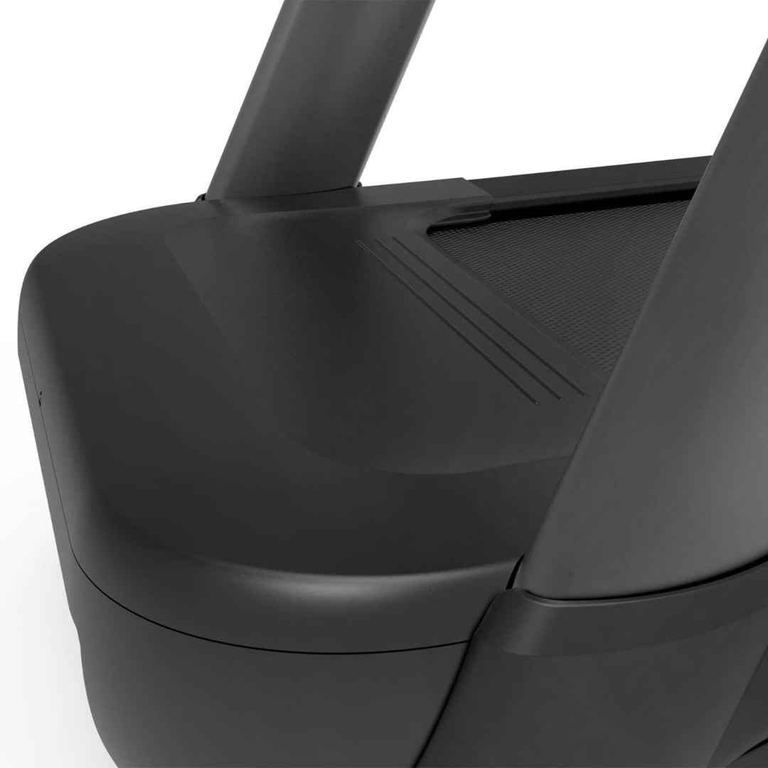 Close-up of a black treadmill with a white background
