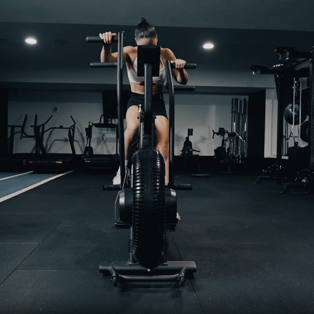 Person using a stationary bike in a gym setting