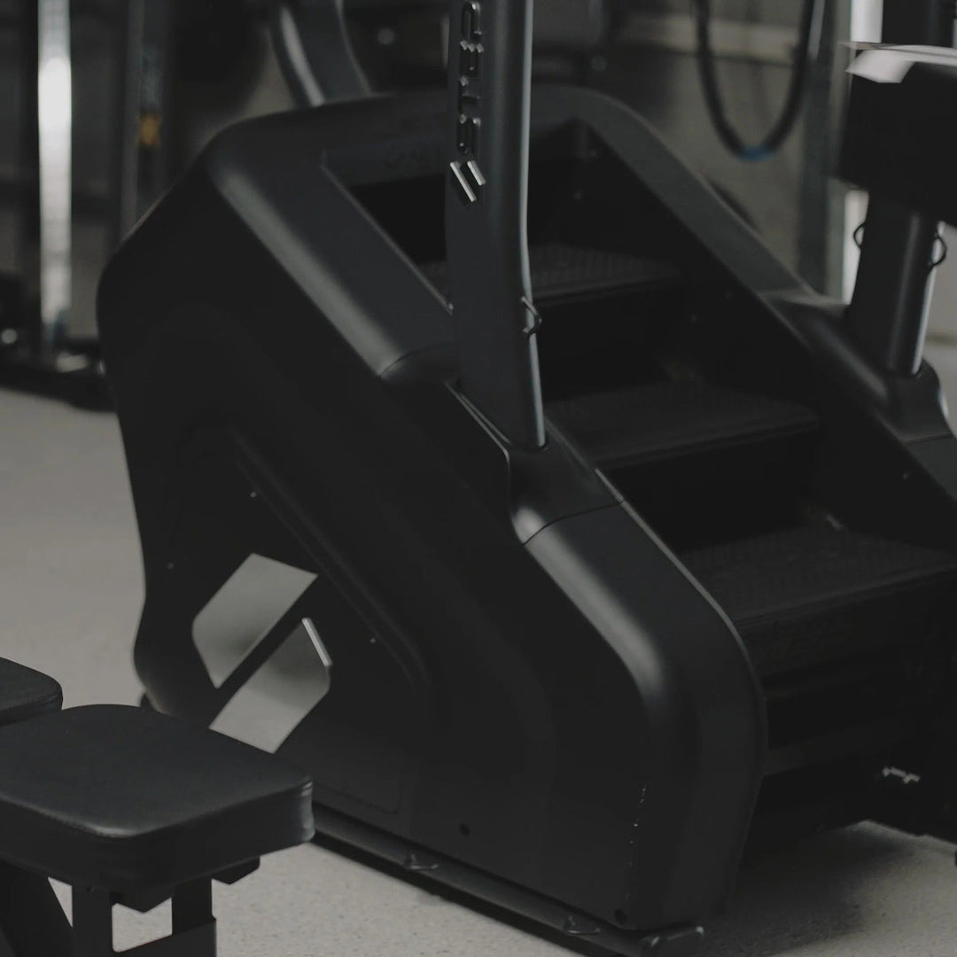 Close-up of a black exercise machine in a gym setting