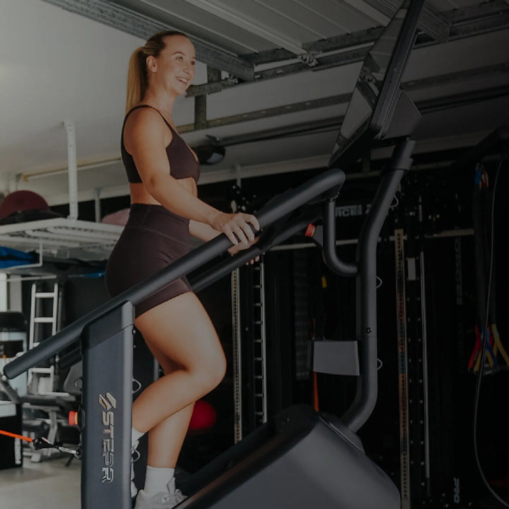 Two women exercising in a home gym setting.
