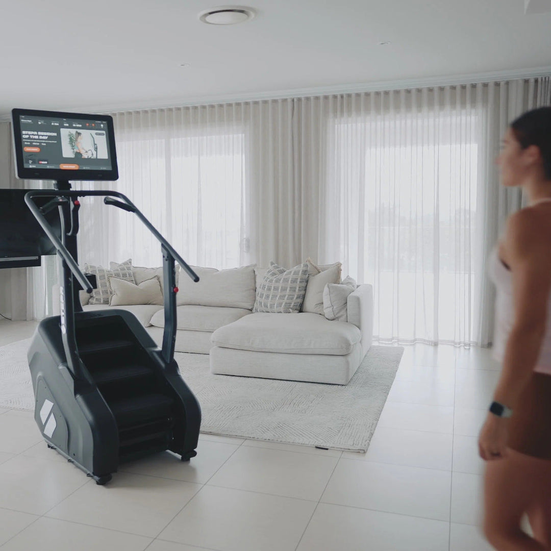 Woman exercising on a stepper in a modern living room.